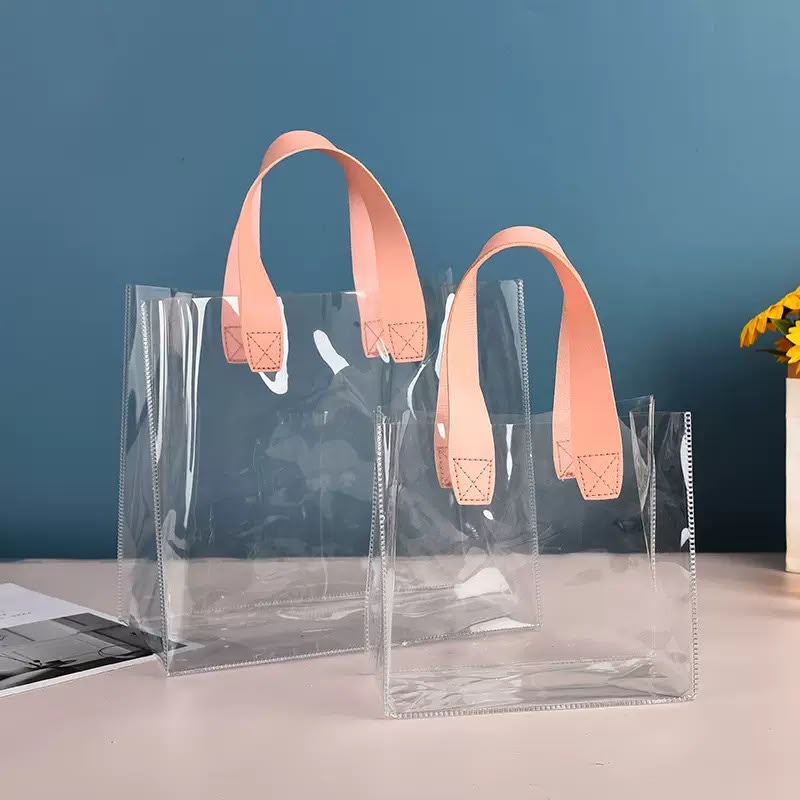 BOLSA TRANSPARENTE CON MANIJA DE CUERINA X10U.